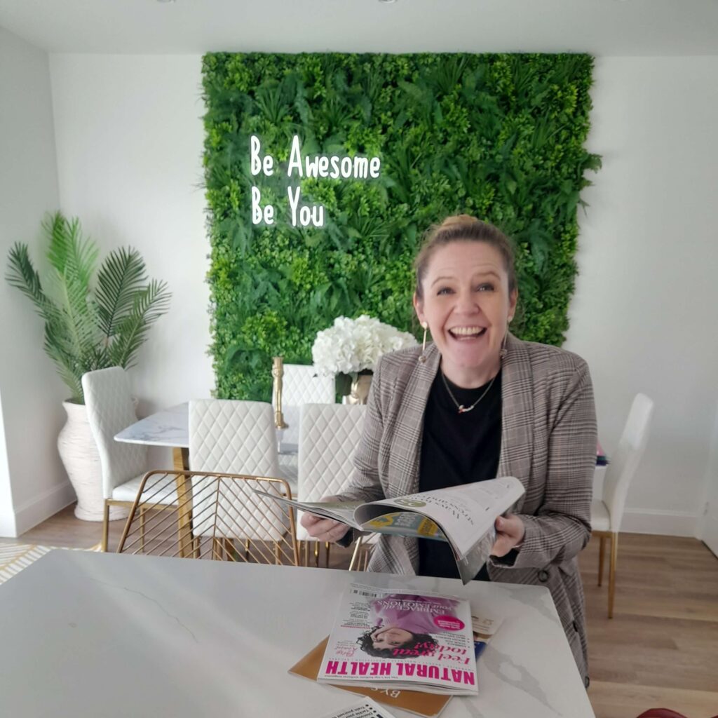 Addicted to Admin reading 'Womens Health' magazine, promoting 'Be Awesome, Be You'.