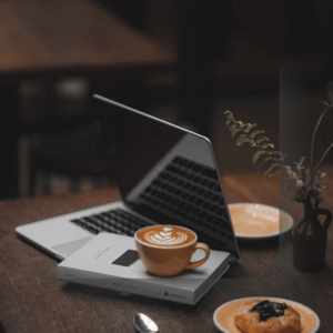 Laptop in a night setting with cup of coffee