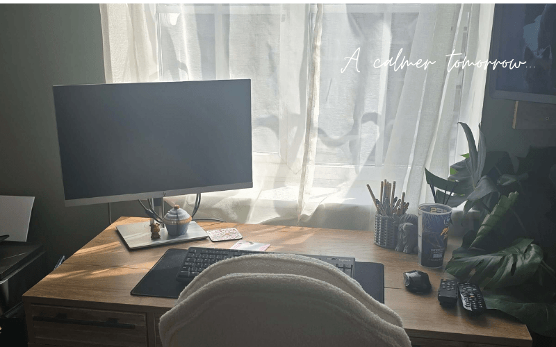 A calm home office desk with the words A calmer tomorrow